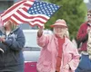 Valley resident Bonnie Conklim waves the U.S. flag as members of the armed forces make their way along the Fourth of July Parade route Wednesday in Wasilla. ROBERT DeBERRY/Frontiersman