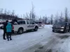 An Alaska State Trooper advises a snowshoer on how to stay safe on Gold Mint Trail after an avalanche closed the road past the Gold Mint parking lot on Tuesday afternoon. Officials say the ro