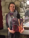 PHOTO BY MARY LOCKMAN / Frontiersman.comWhaley Schmoyer stands in front of the fire place at Jitters coffee shop on Sunday, Jan. 29 with one of her pieces. Schmoyer hung the new show, which w