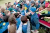 Participants in the Moose Nugget Regatta put all hands in for a cheer before the start of Saturday’s competition on Wasilla Lake. ROBERT DeBERRY/Frontiersman.com