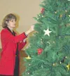 Babetta Daddino hangs the lights on the Light Up a Life
Christmas tree at the Cottonwood Creek Mall. The trees help raise
money and awareness for Hospice of Mat-Su. Photo by CASEY
RESSLER/Fro