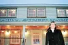 J.J. HARRIER/Frontiersman Delena Johnson stands outside the old
Palmer Trading Post, now the Dahlia Street Market, which re-opened
for business last week. Three new businesses are leased insi