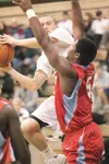 ROBERT DeBERRY/Frontiersman Colony's Scott Herman tries to shoot
around East's Juwan Harris during Friday's game at Colony High
School.