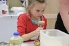 Jillian Ward watches her classmates while rolling out homemade pasta dough in one of the Mat-Su Extension Services' 'Cabin Fever Reliever' classes on Saturday afternoon. CAITLIN SKVORC/Fronti