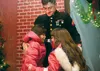 Bailee Wolcoff, 8, cries as she and sister Hollee, 7, hug their brother, Lance Corpral Paul Amore, after he surprised them for Christmas Saturday at the Reindeer Farm in the Butte. Both siste