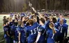 The Palmer Moose celebrate a 33-0 win over Wasilla in the annual Potato Bowl Friday, hoisting the Mayor's Cup traveling trophy. Bruce Eggleston/matsusports.net
