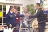 And the winner is … Lydia Shumaker (left), state FFA vice
president, draws a ticket from a cream can so volunteer auctioneer
Gary Feaster (right) can announce a door-prize winner during a
bre