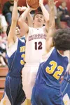 ROBERT DeBERRY/Frontiersman Wasilla sophomore Braydon Kuiper
shoots through a crowd of defenders against the Kodiak Bears during
Friday’s game at Wasilla High School.