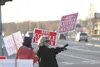 Bert Cottle for Wasilla Mayor supporters hold signs and wave to passing traffic Tuesday evening. HEATHER A. RESZ/Frontiersman