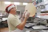 Tech. Sgt. Lee Unick, 673d Force Support Squadron food service specialist, prepares pizza dough at the Iditarod Dining Facility. The Iditarod offers four meals a day: breakfast, lunch and din