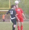 JEREMIAH BARTZ/Frintiersman Colony’s James Meaney, left, and
Wasilla’s Alden Lee both go for the header at midfield during a 2-2
tie at Wasilla High School on Saturday. Meaney scored both of
