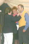CHRIS GILLOW/Frontiersman Mat-Su Borough Mayor Curt Menard
receives his Wasilla Rotary Club pin from Maryalice Larson after
being awarded a lifetime membership Thursday. Gov. Sarah Palin,
cen