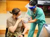 Senior Airman Marisol Salgado, medical technician, administers a Pfizer-BioNTech COVID-19 vaccine to Army Capt. Rebecca Parrish, a COVID-19 intensive care unit nurse, Dec. 17, 2020 at Brooke 