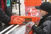 Mason McIntyre, 7, watches as Kevin Weeks measures the fish McIntyre caught in the 2015 Mat-Su Kids Ice Fishing Derby. McIntyre’s father said the family isn’t big on ice fishing but still par