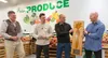 Division of Agriculture Director Brian Scoresby, left, and Three Bears Alaska Marketing Manager Kris Carlson, inside left, present the annual Golden Carrot Award at Three Bears in Wasilla Tue
