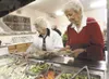 Patty Hendrickson, left, and Vivian Giroux work their way around
the salad bar during lunch at the Palmer Senior Center. The center
provides 250 meals a day for area seniors. (ROBERT DeBERRY/