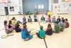 Machetanz Elementary School physical education teacher Christa Hayes talks about proper tennis technique with a group of fifth-grade students Monday morning. Robert DeBerry