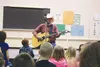 Hobo Jim performs ‘The Legend of Abiyoyo’ for Swanson Elementary School students at their annual family night celebration and potlatch Friday evening. Joining Alaska’s troubadour in performan