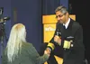 U.S. Surgeon General Dr. Vivek Murphy, shakes the hand of a woman asking a question during his ‘fireside’ talk with Alaska’s Chief Medical Officer Dr. Jay Butler on Thursday at the Massey The