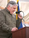 Menard Center manager Scott Bell does a little fist pump while describing the success of the Arctic Winter Games while speaking at the Wasilla Chamber of Commerce's 2024 State of the City of 