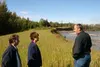 U.S. Senate candidate Mike Miller, Valley senator Lyda Green and
Matanuska Electric Association Operations Manager Bob Drake inspect
erosion of the Matanuska River Friday afternoon. Photo by 