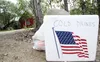 A cooler of cold drinks sits in front of a home in a subdivision near Mile 73, Parks Highway in Willow offering refreshment to the firefighters working in the area during the Sockeye fire las