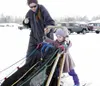 Annalise Byrd, 3, rides the runners as Karin Hendrickson gives
her mushing tips. Hendrickson was at the Willow Library with the
children during a recent Story Hour program. Photo by JODI
SNYD