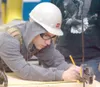 Alaska Job Corps student Jeff Cowan marks a measurement on a
piece of plywood that will become part of a dog house for the
Mat-Su Borough Animal Care Facility. The carpentry class is
construc