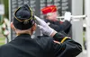 A member of the American Legion 35 Color Guard salutes while Hank Hartman plays Taps at the 2024 Memorial Day Celebration at the Veterans Wall of Honor in Wasilla. J. David McChesney/Frontier