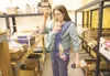ROBERT DeBERRY/Frontiersman Ludie Baranek, with her daughter
Sophia, works the phones and fills a small order for a customer
Friday afternoon in Wasilla.