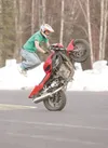 ROBERT DeBERRY/Frontiersman Freestyle Syndicate team member Chad
Wilson works on a trick where he runs behind the bike while holding
on to the bars and then jumps up onto the gas tank all whi