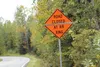 New road signs on Outer Spring Loop near S. Kaye Marie Drive indicate to drivers whether the tracks ahead are passable, or blocked by a gravel train. Coming are real-time web camera views and