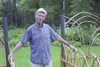 Les Brake stands for a photo in front of an alder gate frame
made by partner Jerry Conrad for their Coyote Garden in Willow. The
garden is one of the highlights of Willow Garden Club’s annual