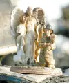 ROBERT DeBERRY/Frontiersman A small figurine of an angel
standing over a fireman holding a baby was spared major damage from
a fire last week at Big Lake Alaska Automated Storage. The figurin