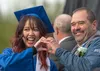 After getting her diploma, Napachanok Santiparadonkul and Palmer High principal David Booth make a heart for her photo. J. David McChesney/Frontiersman