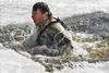 A Fort McCoy Cold-Weather Operations Course (CWOC) Class 22-04 student participates in cold-water immersion training Feb. 18, 2022, at Big Sandy Lake on South Post at Fort McCoy, Wis. CWOC st