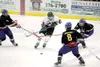 ROBERT DeBERRY/Frontiersman Houston Hawk Dillon Styers charges
through three Lathrope Malamutes during the first period of
Thursday's game at the Curtis C. Menard II Memorial Ice Rink.