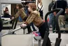 Sarah Bell takes a closer look at the excerise equipment in the new Active Body Downtown Gym in the Koslosky Building while her mother tours the place at the grand opening on Friday, Oct. 30.