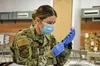 1st Lt. Caleena Longworth with Joint Task Force 17 prepares a syringe with the Moderna vaccine at the Las Vegas Readiness Center, Wednesday, Jan. 27, 2021 in Las Vegas, Nevada. Staff Sgt. Mat