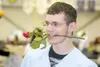 GREG JOHNSON/Frontiersman Damen Hunt poses for a photograph with
a rose in his teeth minutes before the Burchell High School class
of 2010 entered the arena Monday at the Curtis D. Menard Mem