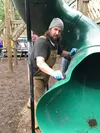 Ryan Butcher led the volunteer charge Aug. 11 to clean and paint over the graffiti left at Palmer’s AMooseMent playground. Courtesy Barbara Hunt