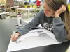 Junior Clara Burnett perfects her fore-shortened self-portrait during AP Art studio at Wasilla High School. Students in AP Art work to complete a comprehensive portfolio to submit to the Coll