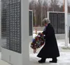 Wasilla Mayor Glenda Ledford places a wreath at the Veterans' Wall of Honor during the Veteran's Day ceremony, marking the 104th observance of the service and sacrifice veterans have made in 