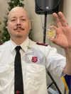 Major Kevin Bootjen holds the gold Krugerrand coin that appeared in one of the Salvation Army red kettles on Thursday. This is the 6th year in a row a Krugerrand coin has been found in one of