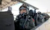 Capt. Toai Dang, from Vietnam Air Defense-Air Force, puts on his helmet while settling into a T-6 Texan II, preparing for his final check ride May 29, 2019, at Columbus Air Force Base, Missis