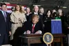 {span}President Donald Trump signs S.1790, the National Defense Authorization Act for Fiscal Year 2020 as senior leaders look on, Friday, Dec. 20, 2019 At Joint Base Andrews. The act authoriz