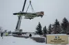 Members from the 3rd Maintenance Squadron assigned to the 3rd Wing, and Alaska Crane civilian contractors hoist the McDonnell F-4C Phantom II static display in front of the Government Hill Ga