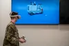 U.S. Air Force Senior Airman Aaron Keys, a Fuels Service Center accountant from the 673d Logistics Readiness Squadron, demonstrates a virtual-reality training aid on Joint Base Elmendorf-Rich