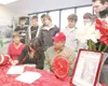 ROBERT DeBERRY/Frontiersman Jordan Elkins, center, flanked by
her parents Brent and Jessie Laub-Elkins, and fellow Wasilla team
members, signs her letter of intent to play at Quinnipiac
Unive