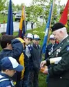 Brigadier General Thomas Westall presents merit badges to a
group of Cub Scouts at a tree-planting ceremony Monday evening.
Photo by DANIEL SPOTH/Frontiersman.